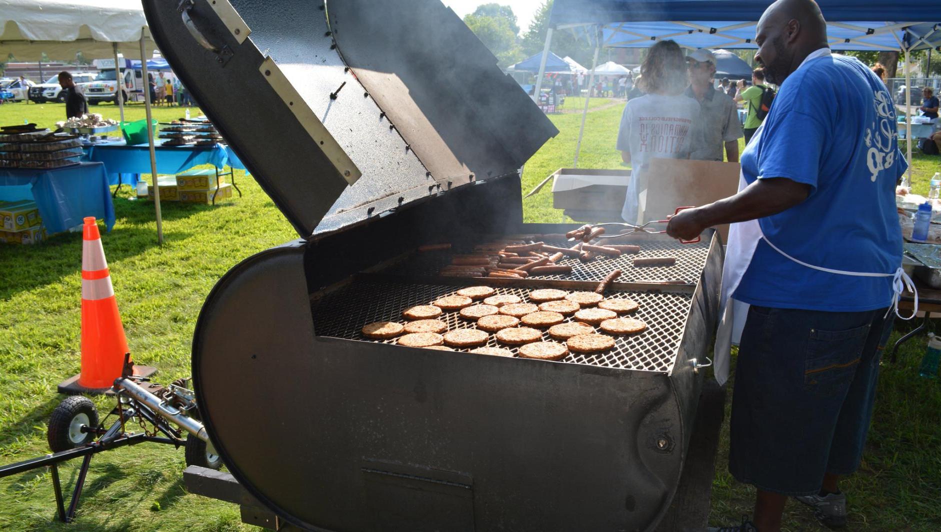 A man works at the grill. 