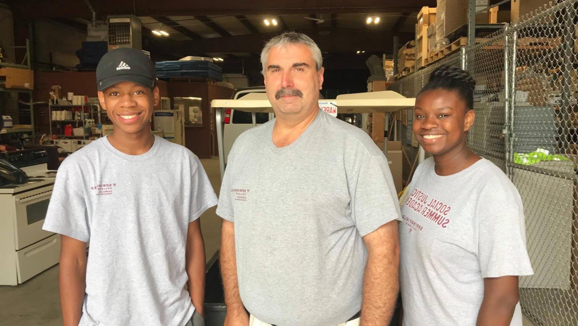 Students workers pose with their boss. 