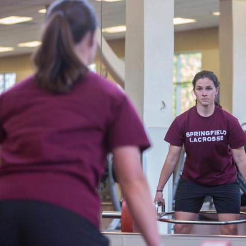 Student lifting weights. 