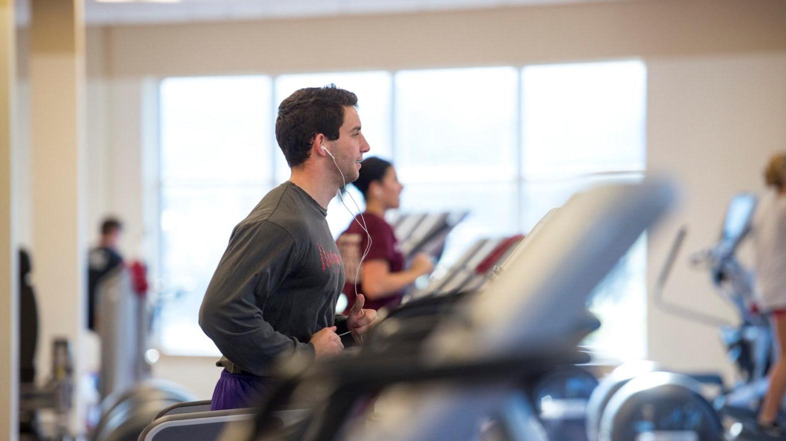 Male student works out in the Wellness Center within the Springfield College Wellness & Recreation Complex 