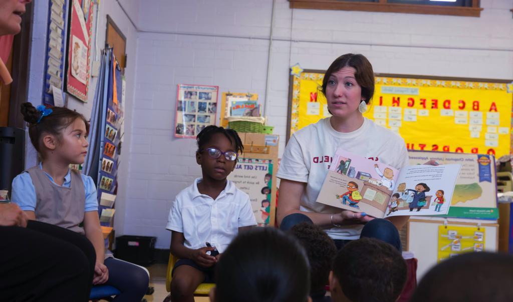 Education student reading to classroom