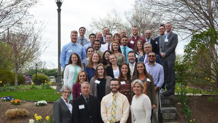 Student Government Association and Graduate Student Organization members pose on the steps of Springfield College with the President's Leadership Team